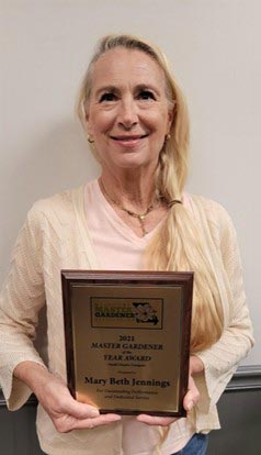 Mary Beth Jennings holding her award plaque.