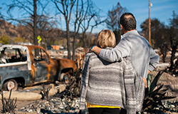 Couple surveying the scene after a disaster