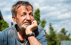 Older male farmer deep in thought