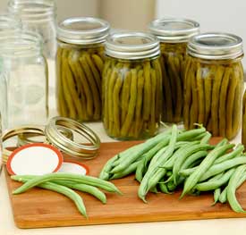 jars of beans and beans on a table.