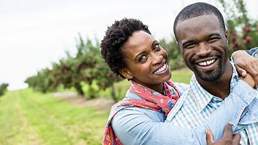 A couple standing on a trail.