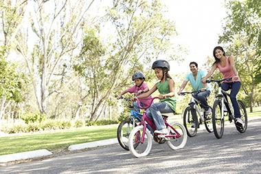 A couple and their kids riding bikes enjoying each others company