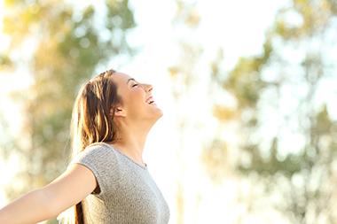 Woman enjoying the sunshine on her face and relaxing