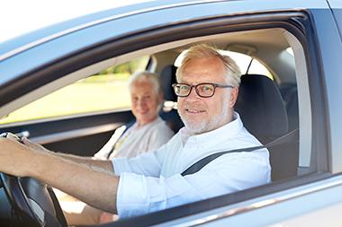 Senior couple driving a car