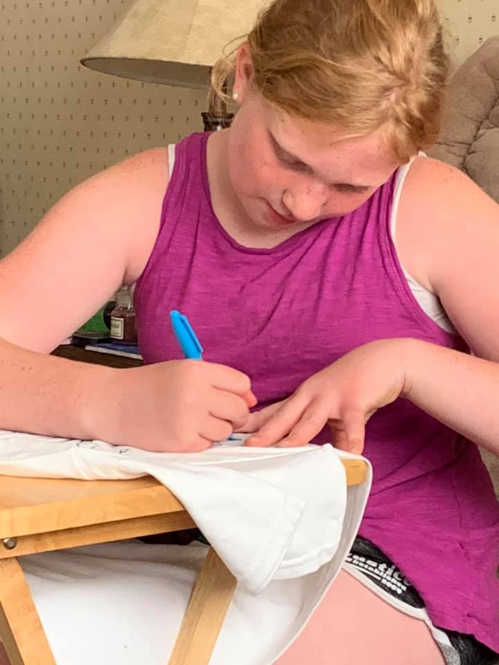 Mattalie, 11, of Saline County, decorating her 'Party in the USA' themed T-shirt, a Heit's Point 4-H camp tradition.