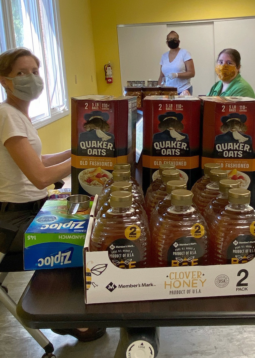 From left, nutrition specialist Leslie Bertsch, 4-H youth program associate Terry Olishile and 4-H field specialist Melissa Sheer put together Healthy Habits bags with recipes and ingredients.