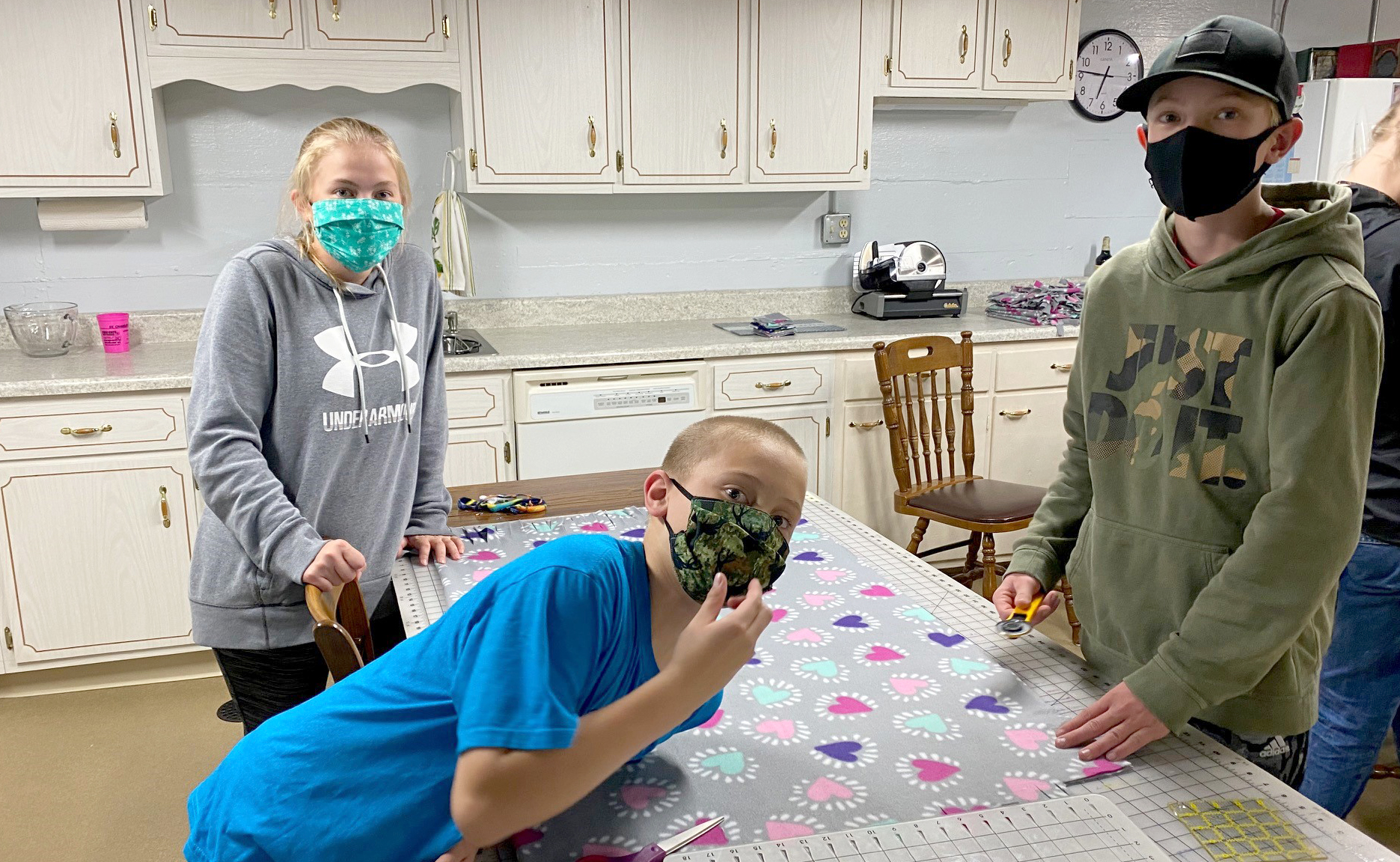 From left, St. Charles County 4-H'ers Sophia Bello, Eric Bello and John Zumbehl making blankets for Project Linus.