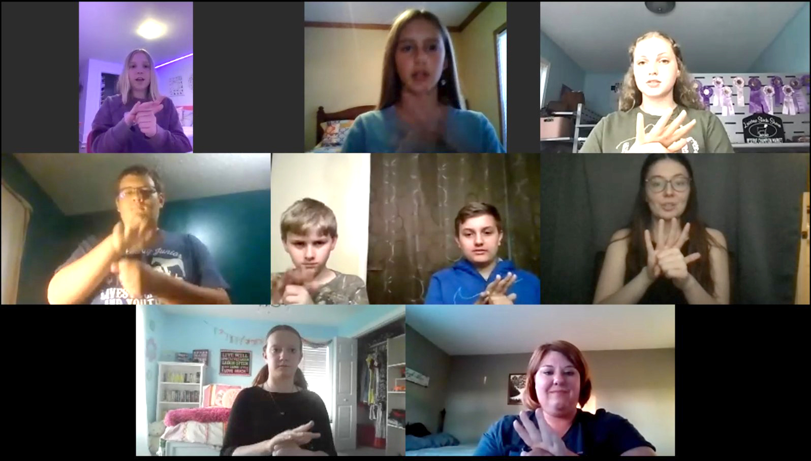 Aynsley Harmon, bottom left, and fellow 4-H’ers practice the reciting the 4-H pledge(opens in new window), led by DeafLEAD’s Nicole Hohlt, middle row, right; and Katie Hogan, MU Extension engagement specialist in 4-H youth development, bottom right.