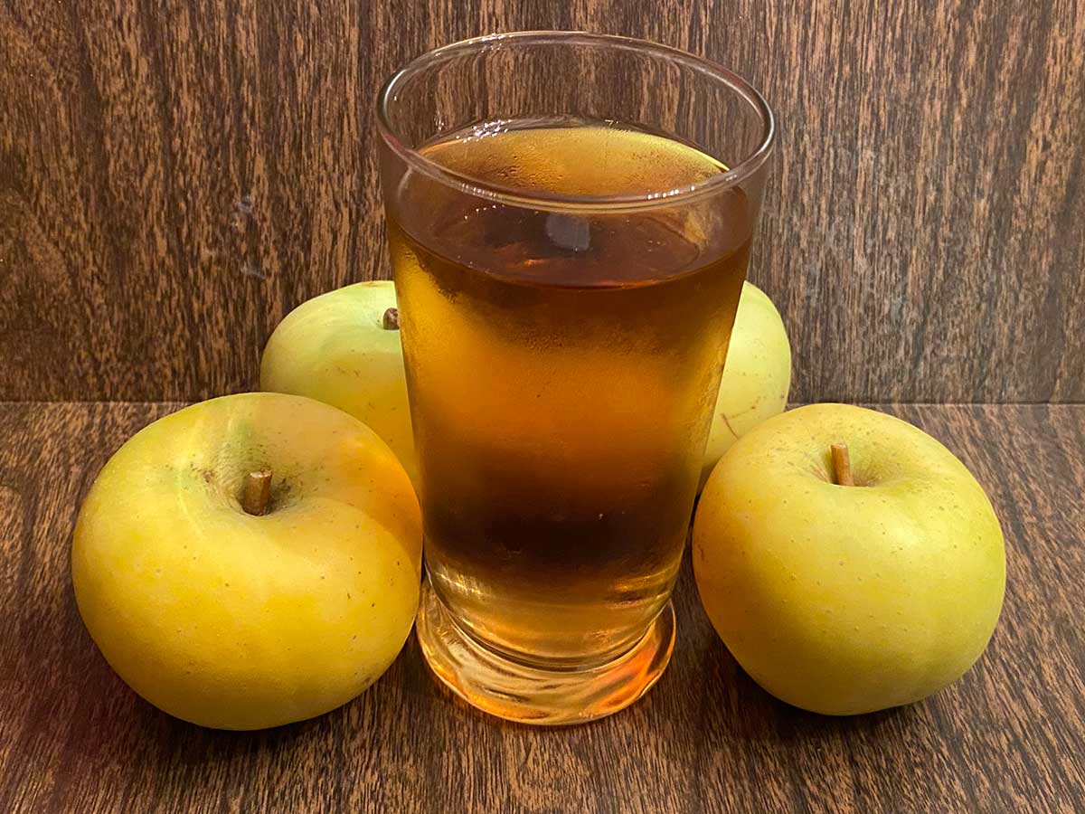 Bittersweet Harrison apples are pressed for juice for making hard cider blend. Stock photo.