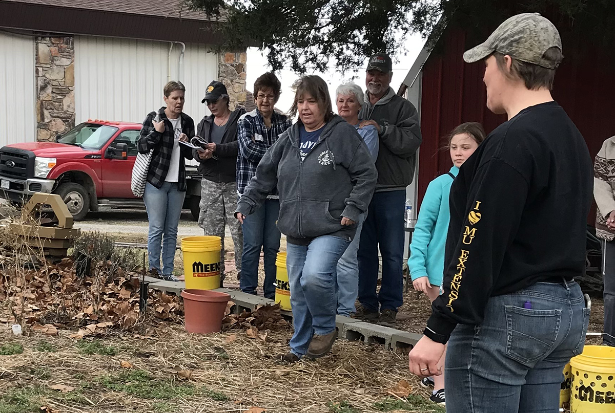 MU Extension specialist Reagan Bluel, right, at a Victory Over the Virus event at a church community garden in Shell Knob.