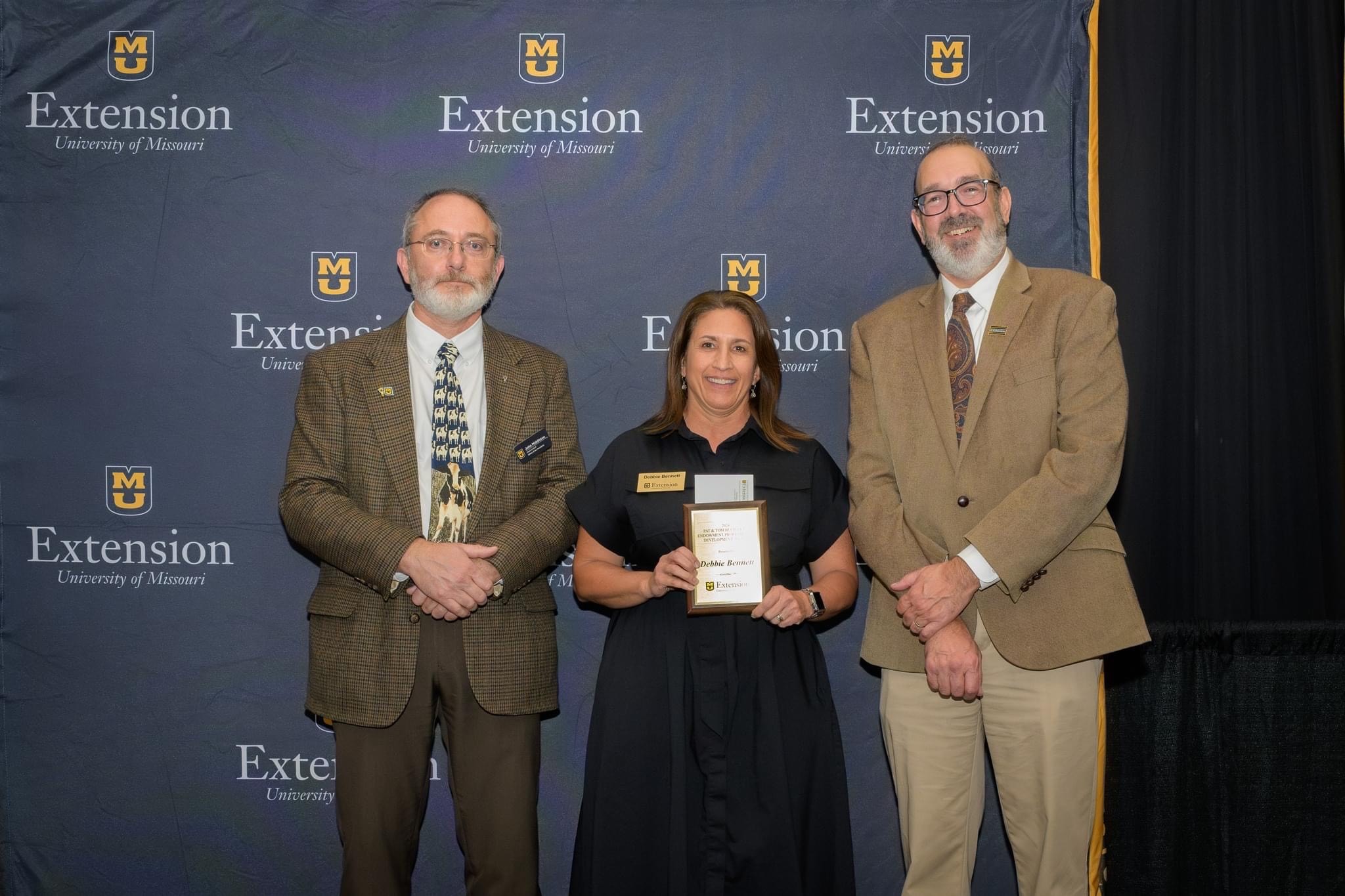 Debbie Bennett, center, field specialist in nutrition and health, receiving the Pat & Tom Buchanan Endowment Professional Development Award.