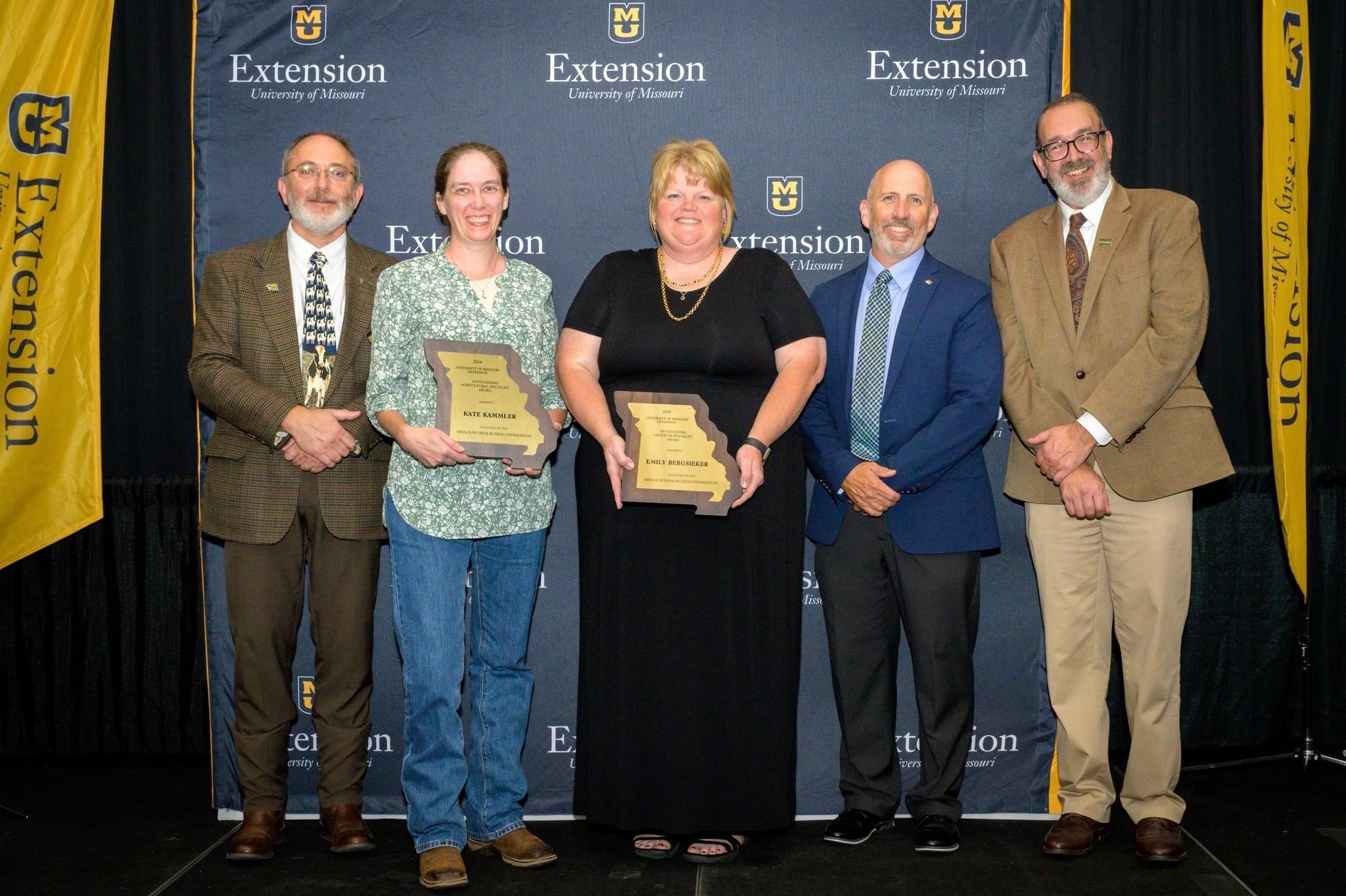 Field specialist in 4-H youth development Emily Bergsieker, second from left, receiving her joint award nominated by her county Farm Bureau board and county extension council.