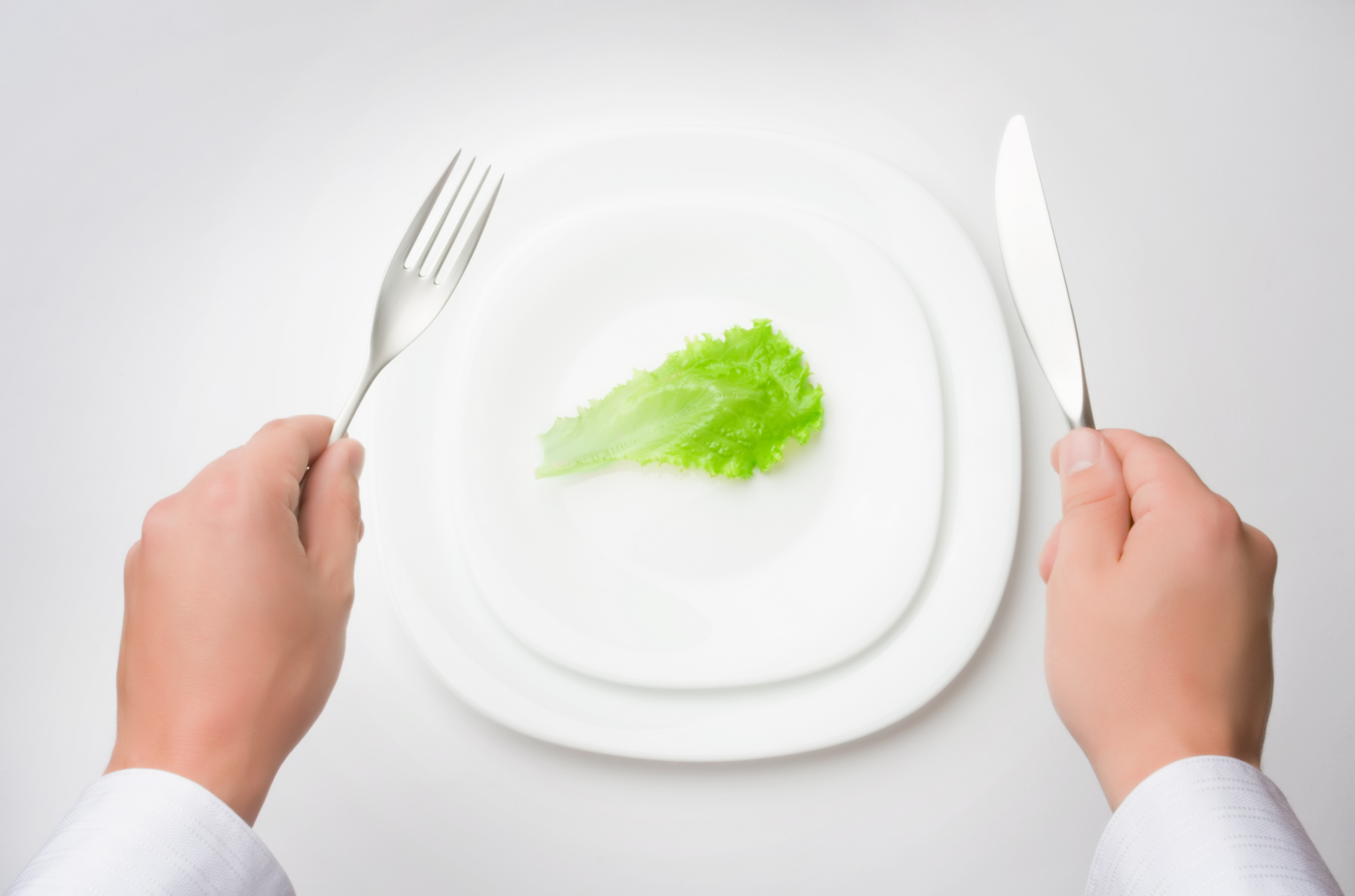 lettuce on plate with fork and knife