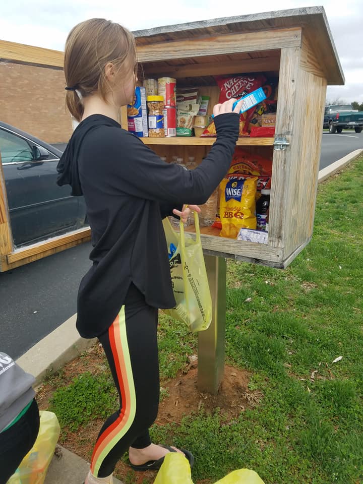 This 'little free library' box has been repurposed for community food donations.