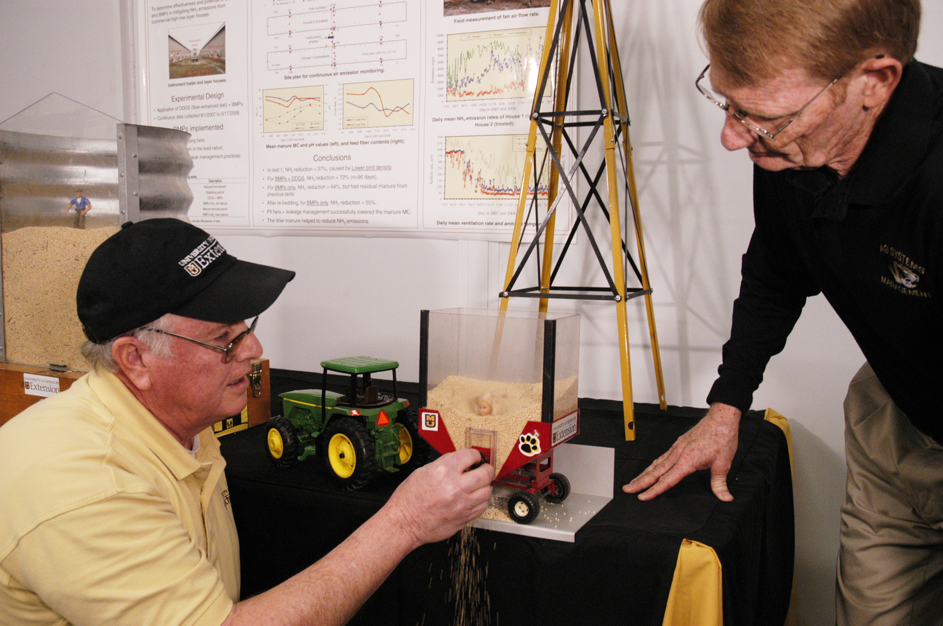 MU Extension specialists Frank Wideman, left, and Willard Downs demonstrate how quickly a person can be entrapped in grain wagons and bins. Linda Geist, University of Missouri Extension