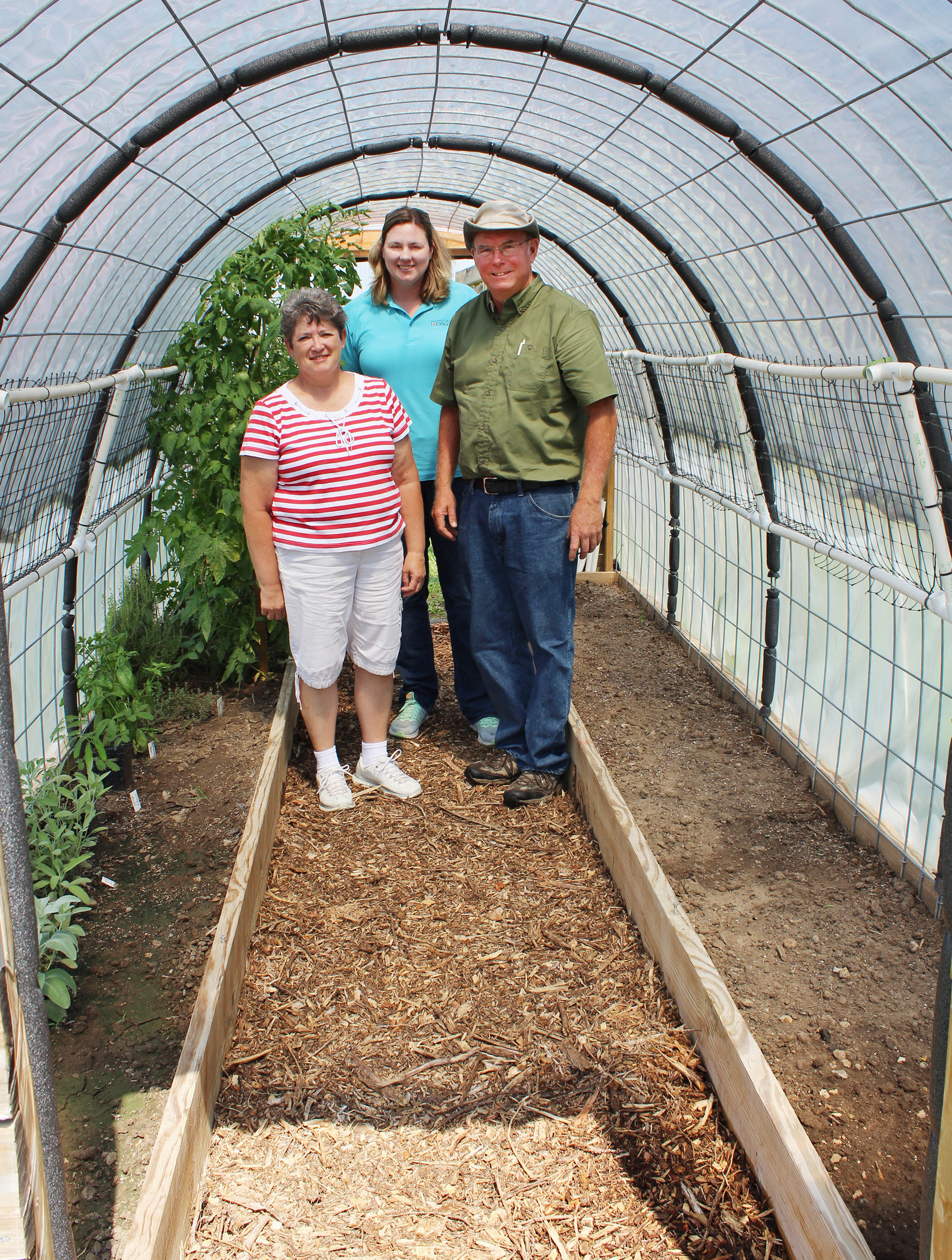 Ozark Prairie Master Gardener Dan Britton, right, his wife, Earlene, left, and MU Extension specialist Joni Harper, center, are teaching other Master Gardeners how to make small greenhouses.Photo by Linda Geist